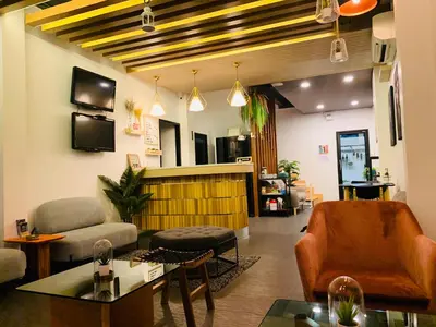 a living room with a couch and a table at Daraya Hostel in Bangkok