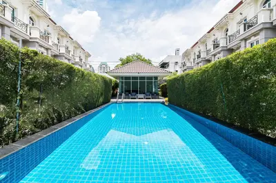 a swimming pool in front of a building at MIQ Asoke808 Villa - Asoke BTS - garden pool - 16 Pax in Bangkok