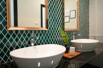a bathroom with two sinks and a mirror at KLYDE Boutique - Chatuchak in Bangkok