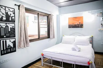a bed in a room with a window at Bangkok Canale Home at Khaosarn in Bangkok