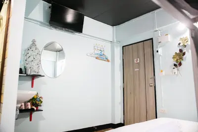 a bedroom with a door and a mirror at Bangkok Canale Home at Khaosarn in Bangkok