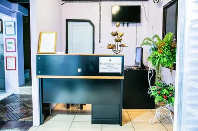 a desk in a room with potted plants at Bangkok Canale Home at Khaosarn in Bangkok