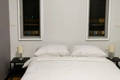 a white bed with two windows in a bedroom at U4 Large 2 bed rooms full kitchen 200m to BTS in Bangkok