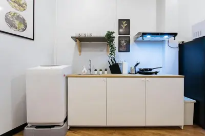a kitchen with white cabinets and a counter at U4 Large 2 bed rooms full kitchen 200m to BTS in Bangkok