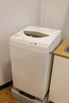 a white washing machine sitting on top of a counter at U2 Large 2 Bedrooms 100m to BTS station in Bangkok