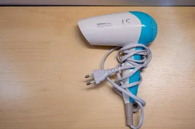 a blue and white blow dryer sitting on a table at B3 Cosy Studio /5 guests/ Near MRT/full kitchen in Bangkok
