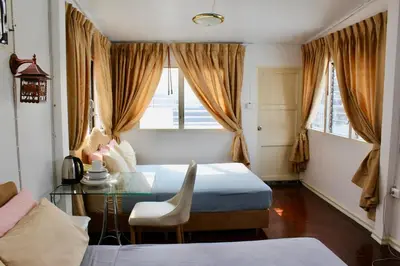 a bedroom with a table and a bed and a desk at C U Again in Bangkok
