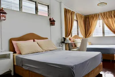 a bedroom with two beds and two windows at C U Again in Bangkok