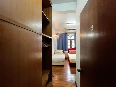 a room with a bedroom with a bed and a door at C U Again in Bangkok