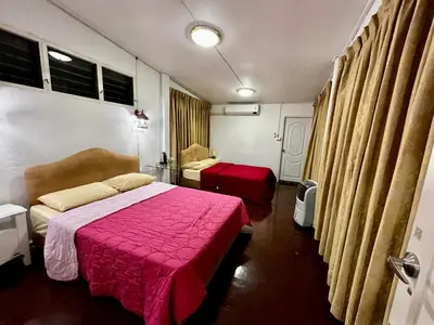 a bedroom with two beds and a red blanket at C U Again in Bangkok
