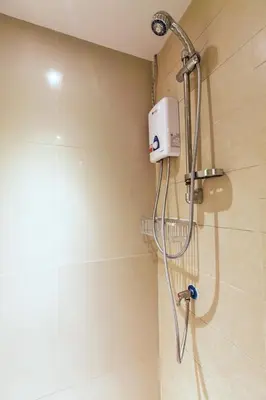 a shower with a shower head in a bathroom at D Day Suite in Bangkok