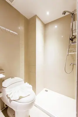 a bathroom with a toilet and a shower at D Day Suite in Bangkok