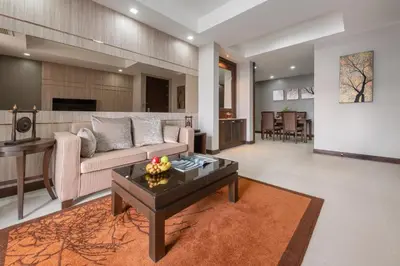 a living room with a couch and a table at Grand Asoke Suites Boutique Residence in Bangkok