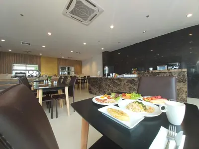a table with two plates of food on it at Grand Asoke Suites Boutique Residence in Bangkok