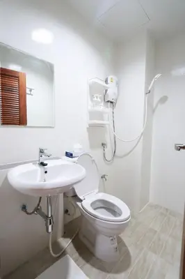 a bathroom with a toilet and a sink at Baanrao Bangson in Bangkok