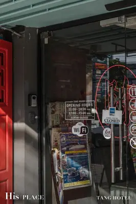 a refrigerator with stickers on the side of it at Tang House in Bangkok