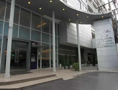 a large glass building with plants in front of it at Lee Garden Bangkok in Bangkok