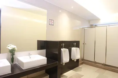 a bathroom with two sinks and a mirror at Lee Garden Bangkok in Bangkok