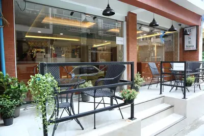 a group of chairs and tables on a patio at Rose Nana Hotel in Bangkok