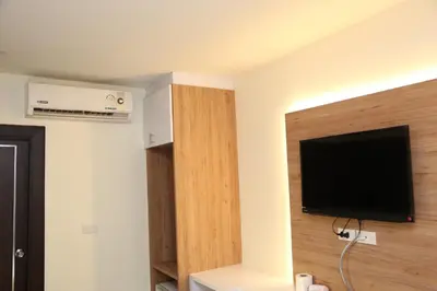 a room with a flat screen tv on a wall at Rose Nana Hotel in Bangkok