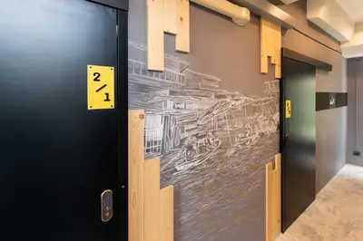 a door with a drawing on the wall at LOBSUEK Hostel in Bangkok