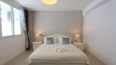 a bedroom with a bed with two white towels on it at Airee Premier Residence in Bangkok