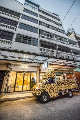 a cheetah print car parked in front of a building at Theme Boutique Hotel Bangkok in Bangkok
