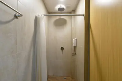 a shower with a shower curtain in a bathroom at StayAt Bedever Bangkok Hotel in Bangkok