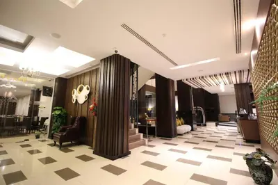 a lobby with a staircase and a lobby at Sky dome resotel - โรงแรมสกายโดม รีโซเทล in Bangkok