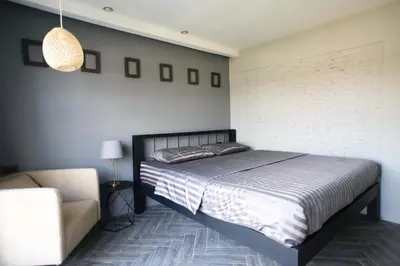 a bedroom with a bed and a couch at 87 Oldtown at River Pier in Bangkok