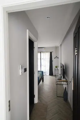 a room with a bed and a room with a hallway at 87 Oldtown at River Pier in Bangkok