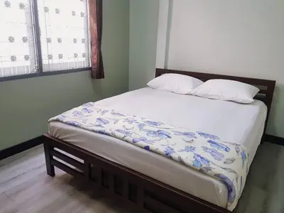 a bed with two pillows on it in a bedroom at Baan U-Sabai บ้านอยู่สบาย in Bangkok