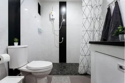 a bathroom with a white toilet and a shower at P4 Silom Large 2beds full kitchen WIFI 4-6pax in Bangkok