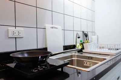 a kitchen with a sink and a pan on a stove at P4 Silom Large 2beds full kitchen WIFI 4-6pax in Bangkok