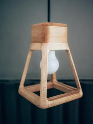 a wooden stool with a vase on it at Haus Sathorn 11 Residence in Bangkok