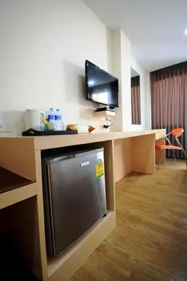 a room with a desk with a tv and a deskictericter at S3 Residence Park in Bangkok