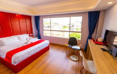 a bedroom with a large bed and a large window at Sapphire Hotel Silom Bangkok in Bangkok