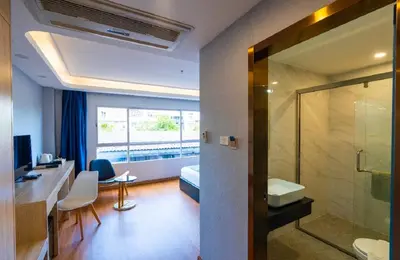 a hotel room with a bathroom with a sink and a shower at Sapphire Hotel Silom Bangkok in Bangkok