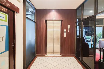 an office lobby with a door and a hallway with glass at Cordia Residence Sathorn in Bang Rak
