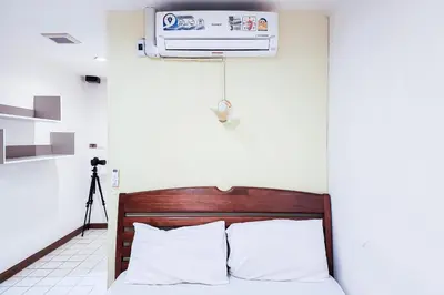 a bedroom with a bed and a air conditioner at Cordia Residence Sathorn in Bang Rak