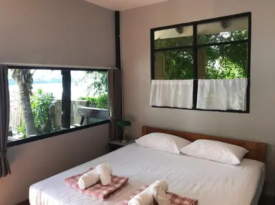 a bedroom with two stuffed animals sitting on a bed at BAANYA HOMESTAY Ko Kret in Nonthaburi