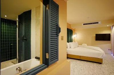 a hotel room with a bed and a bath tub at 4 Monkeys Hotel in Bangkok
