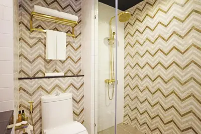 a bathroom with a toilet and a glass shower at 4 Monkeys Hotel in Bangkok