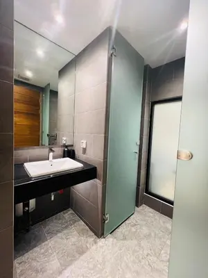 a bathroom with a sink and a shower at Woodstory Boutique Hotel in Bangkok