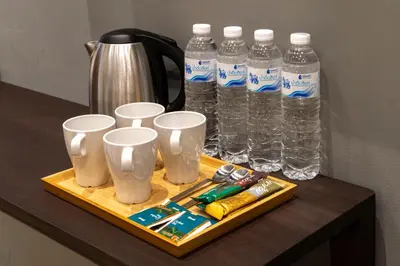 a tray with several bottles of water on a table at Woodstory Boutique Hotel in Bangkok