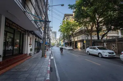 a person riding a bike down a city street at P3 Silom Large 2beds full kitchen WIFI 4-6pax in Bangkok