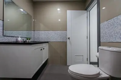 a bathroom with a toilet and a sink and a mirror at P3 Silom Large 2beds full kitchen WIFI 4-6pax in Bangkok