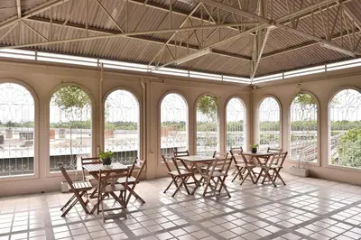 a room with tables and chairs and windows at G9bangkok in Bangkok