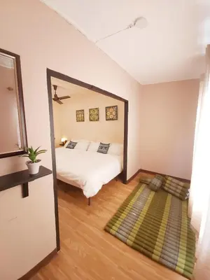 a bedroom with a bed and a large mirror at Real Bangkok Guesthouse Private 3BR Home 3 Min to BTS Ratchathewi in Bangkok