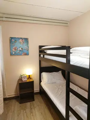 a bedroom with two bunk beds and a lamp at Real Bangkok Guesthouse Private 3BR Home 3 Min to BTS Ratchathewi in Bangkok